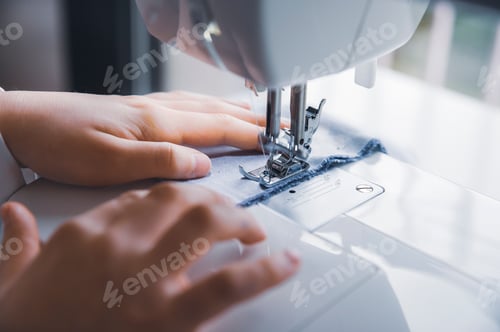 Preview: young girl working with sewing machine