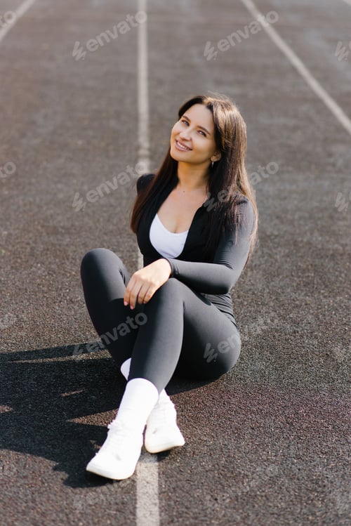 Preview: Relaxed Woman Sitting On Outdoor Track