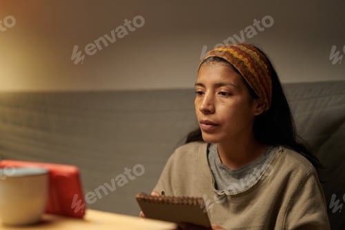 Preview: Contemplating Woman Sitting with Notebook