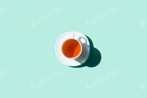 Preview: top view of cup of healthy herbal tea and saucer isolated on blue