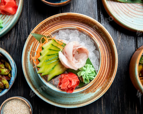 Preview: top view of marinated herring fillets with sliced cucumbers ginger and wasabi sauce