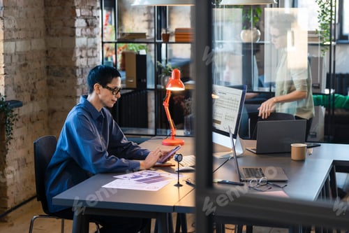 Preview: Businesswoman using mobile phone at work