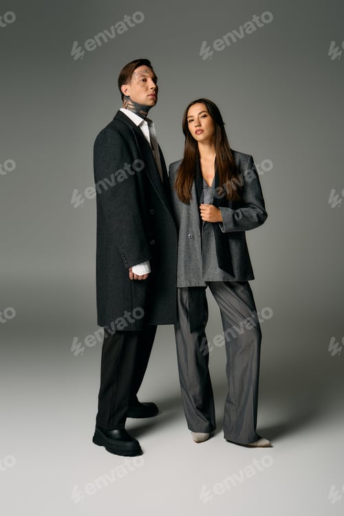 Preview: Young attractive couple in stylish outfits posing confidently in a modern studio setting