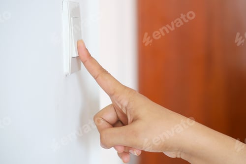 Preview: A finger turning on lighting switch .