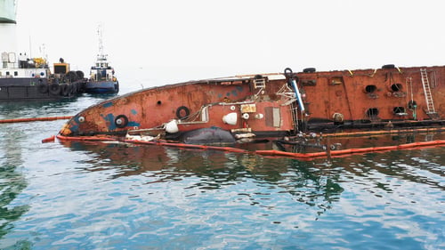 Preview: Close up of broken rusty oil tanker ship in the shallow water.