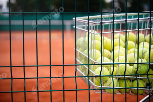 Preview: Tennis balls in basket on background of the tennis court