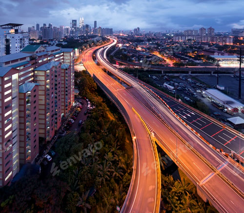 Preview: A long exposure shot at night of highway leading to a city.
