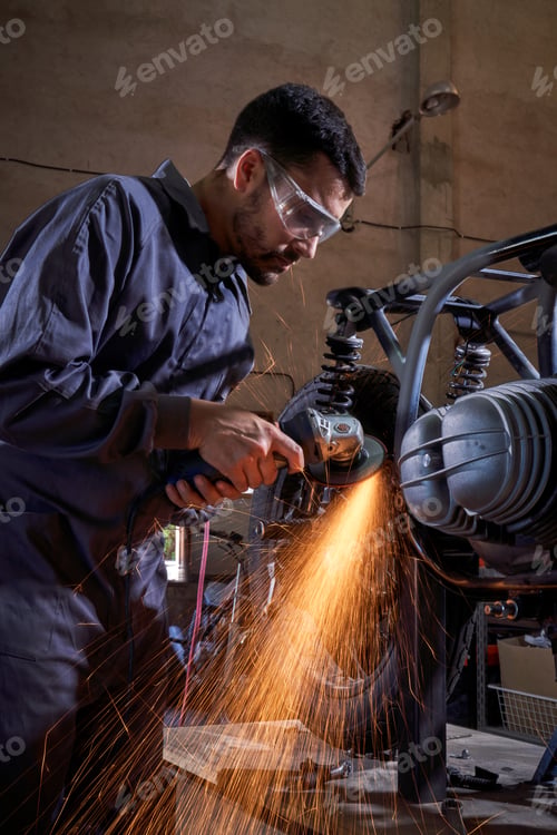 Preview: Man repairing motorbike in garage