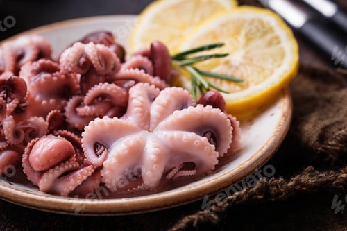 Preview: Baby octopus in plate with lemon and rosemary