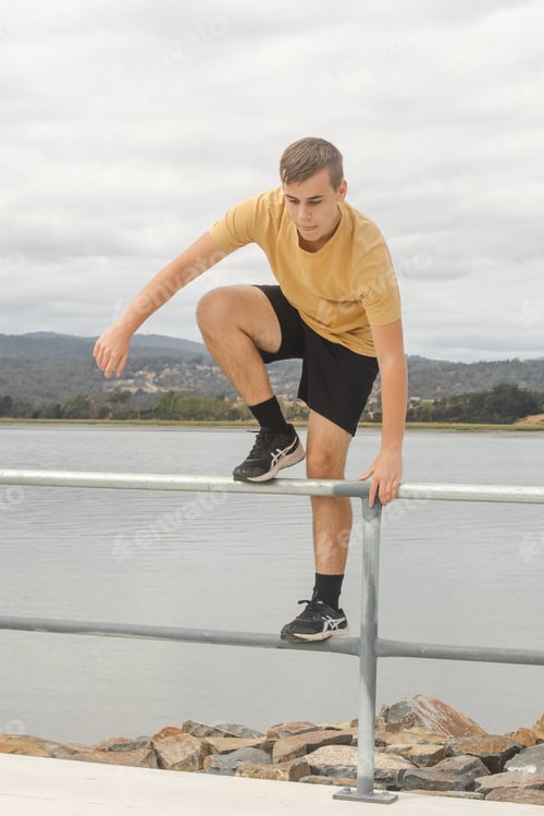Preview: Teenager on Metal Railing by Water