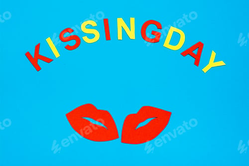 Preview: World Kiss Day. A pair of red lips and inscription cardboard kissing day on a blue background.