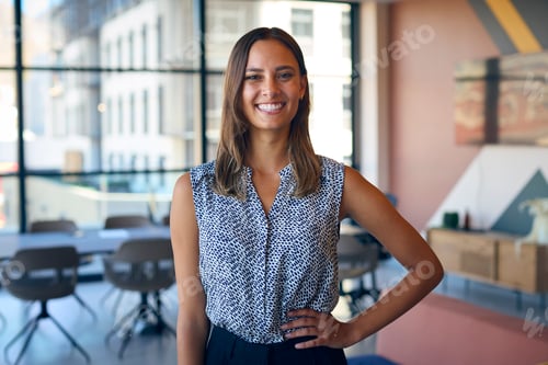 Preview: Portrait Of Smiling Young Businesswoman Standing In Empty Office