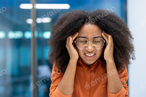 Preview: Headache, sick overworked and stressed woman at workplace close up. Businesswoman holding her head