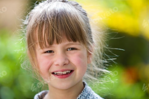 Preview: Cute pretty child girl with gray eyes and fair hair smiling in camera outdoors