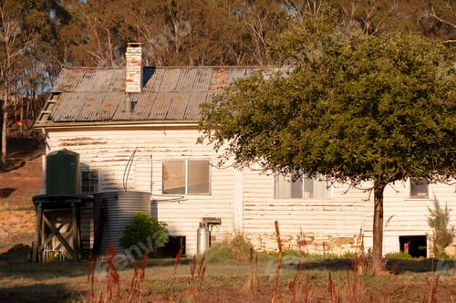 Preview: Rustic Old Farmhouse with Tree in Rural Setting