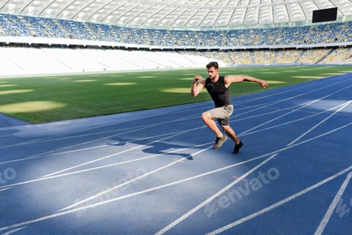 Preview: handsome runner exercising on running track at stadium