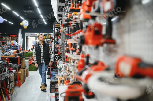 Preview: A man chooses a power tool in a hardware store