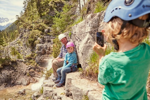 Preview: Father and children taking photograph on hill, Ehrwald, Tyrol, Austria