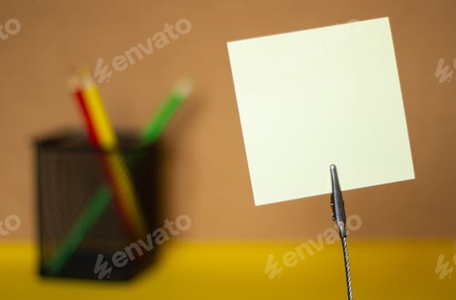 Preview: Stickers and colored pencils on a blurry cork board background, copy space