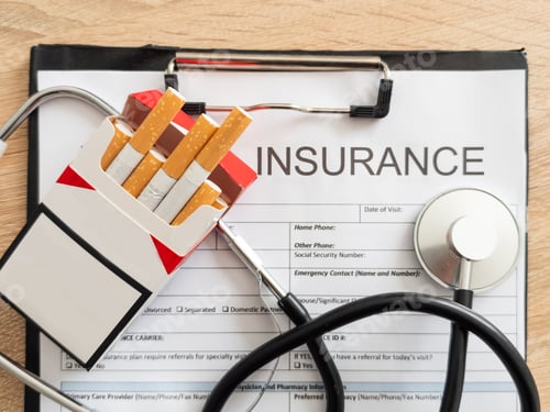 Preview: Cigarettes and stethoscope on insurance documents
