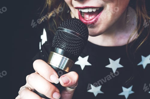 Preview: Young woman singing a song with a microphone