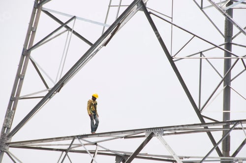 Preview: Pylon construction workers working on the top of power tower.