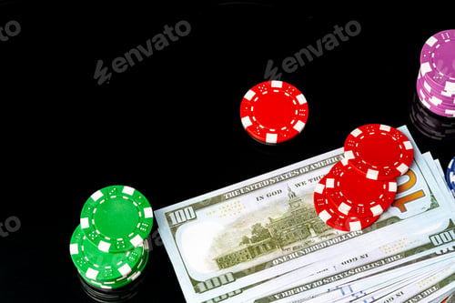 Preview: Poker chips and dollar bills on black background studio shot