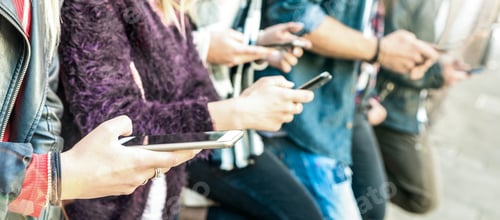 Preview: Multicultural friends group using smartphone at university college backyard break