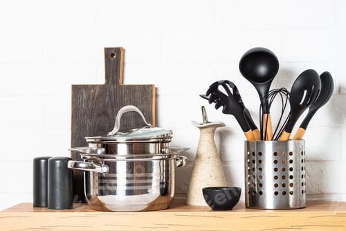 Preview: Kitchen table, kitchen utensils, cooking pots at white kitchen.