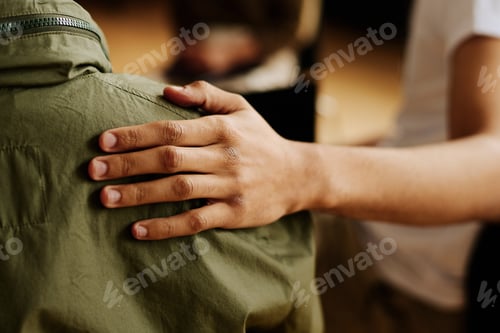 Preview: Hand of young supportive man consoling his friend with post traumatic syndrome