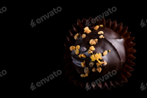 Preview: One Single Handmade Chocolate Praline Close Up View. Dark Background with Copy Space