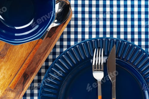 Preview: Deep blue ceramic plate with cutlery close up