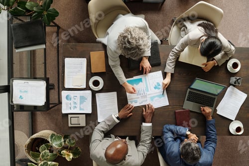 Preview: Diverse Group of Middle Aged Professionals Analyzing Financial Reports Together