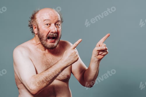 Preview: Front view senior man stand left looking at camera pointing index fingers right mouth say wow