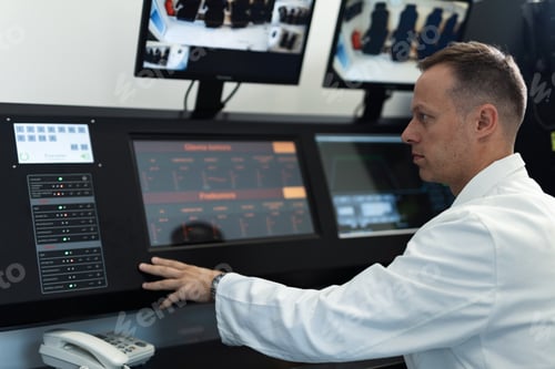 Vista previa: Doctor in control room supervising oxygen therapy process in hyperbaric chamber.