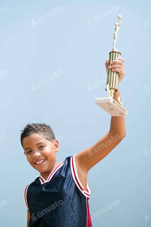 Preview: Boy holding up basketball trophy