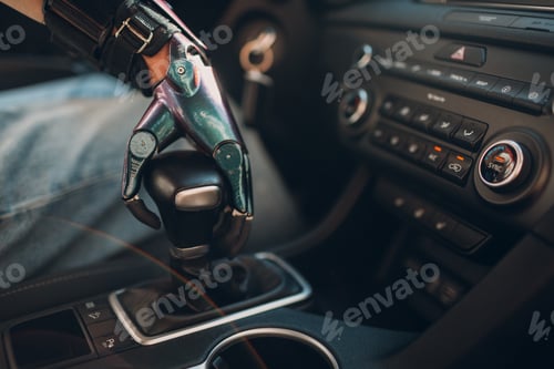 Preview: Young disabled man driver with artificial prosthetic hand driving vehicle car and switches gearbox.