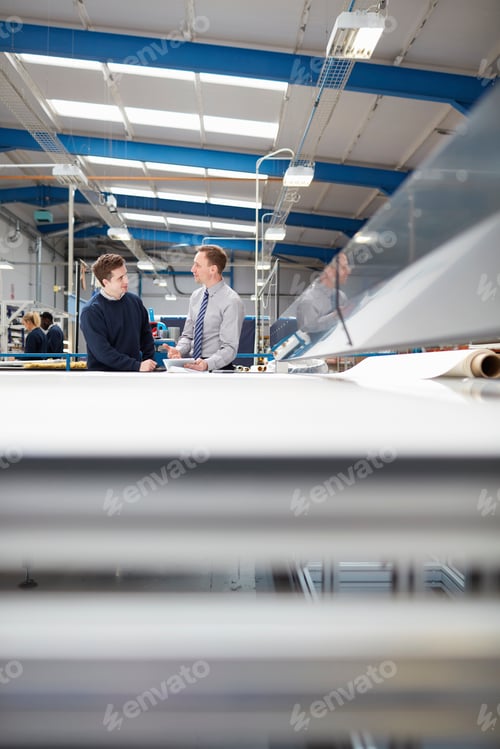 Preview: Manager and factory worker discussing work in roller blind factory