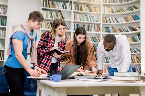 Preview: Group portrait of creative modern multiracial friends university students, preparing for exams in