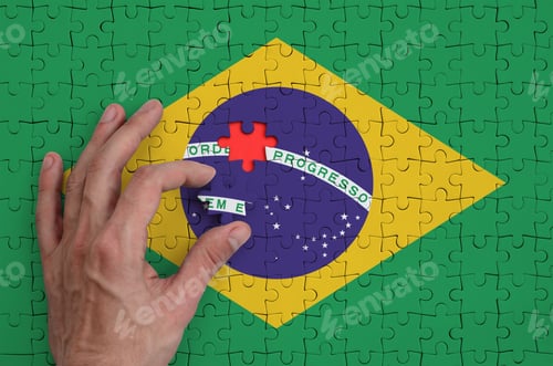 Preview: Brazil flag is depicted on a puzzle, which the man's hand completes to fold.