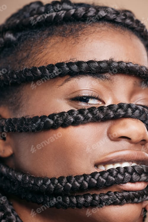 Preview: Cropped portrait of an attractive young woman posing in studio against a brown background