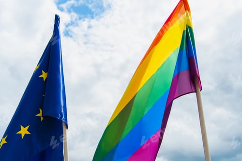 Preview: American and lgbt flags against blue sky with clouds