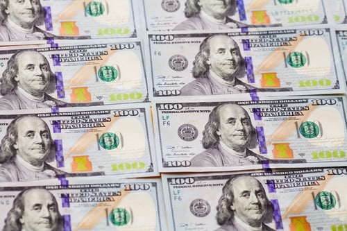 Preview: One Hundred Dollar Bills Laid Out on Table