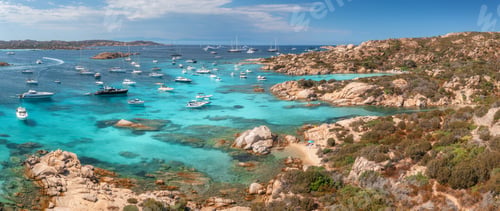 Preview: Recreational boats and luxury yachts mooring in a turquoise bay, granite rocks mediterranean sea