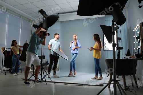Preview: Professional team working with model in photo studio