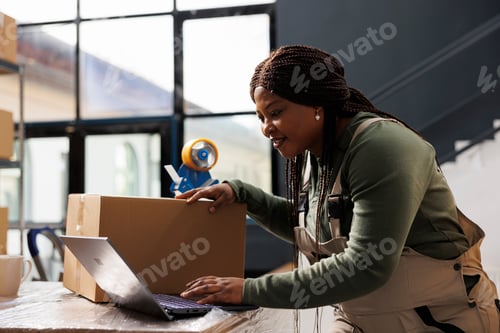 Preview: Storehouse supervisor checking online orders on laptop