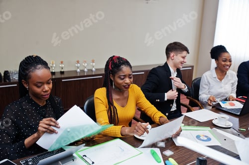 Preview: Multiracial young creative people in modern office