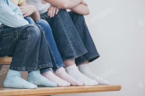 Preview: happy children which are sitting on the stairs in the house.