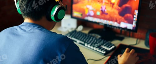Preview: young man playing game on computer, banner