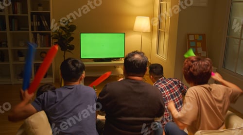 Preview: asian friends or football fans watching soccer on Green Chroma Key Screen and celebrating